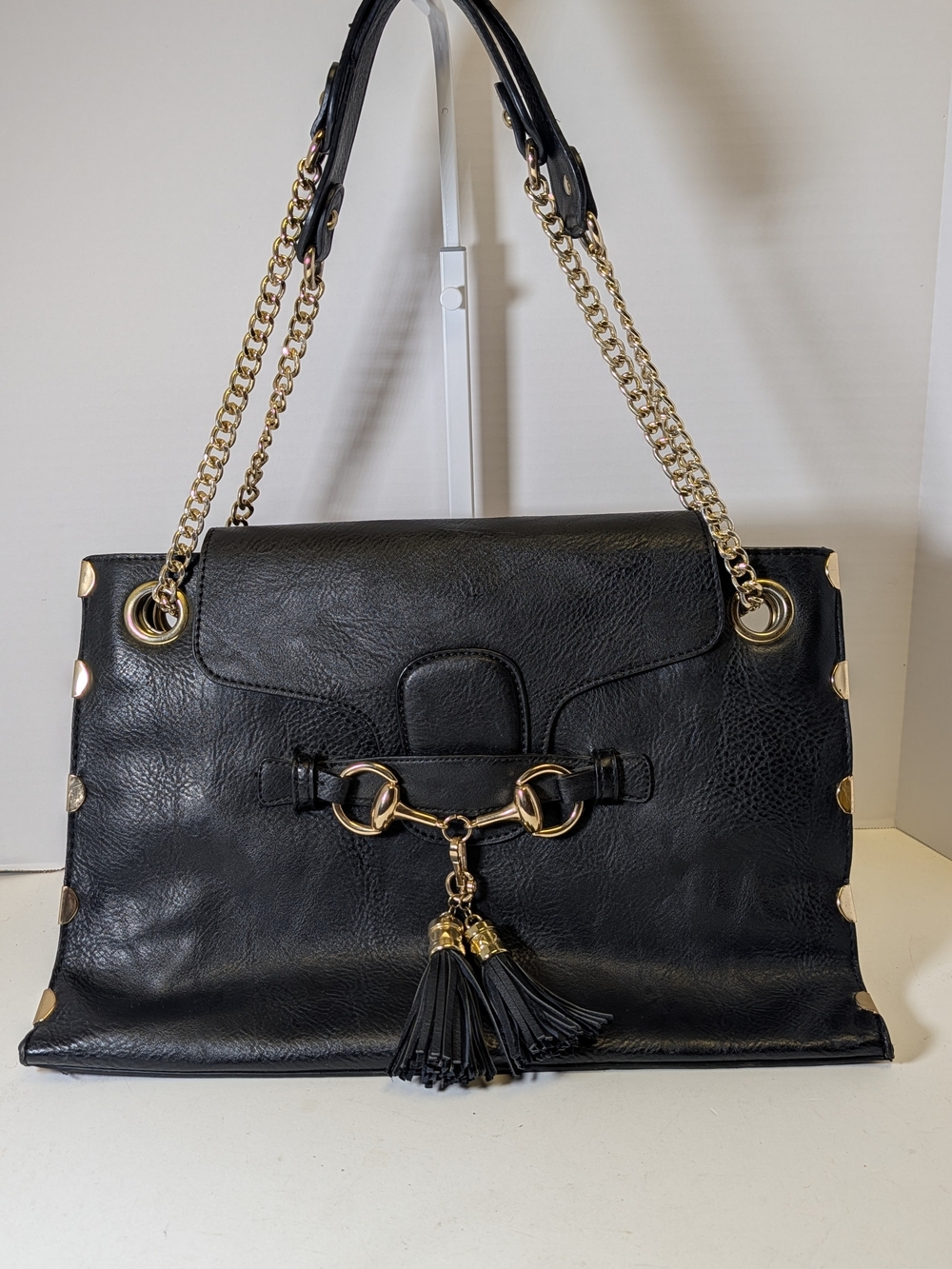 Black Leather Shoulder Bag with Gold Chain and Tassel